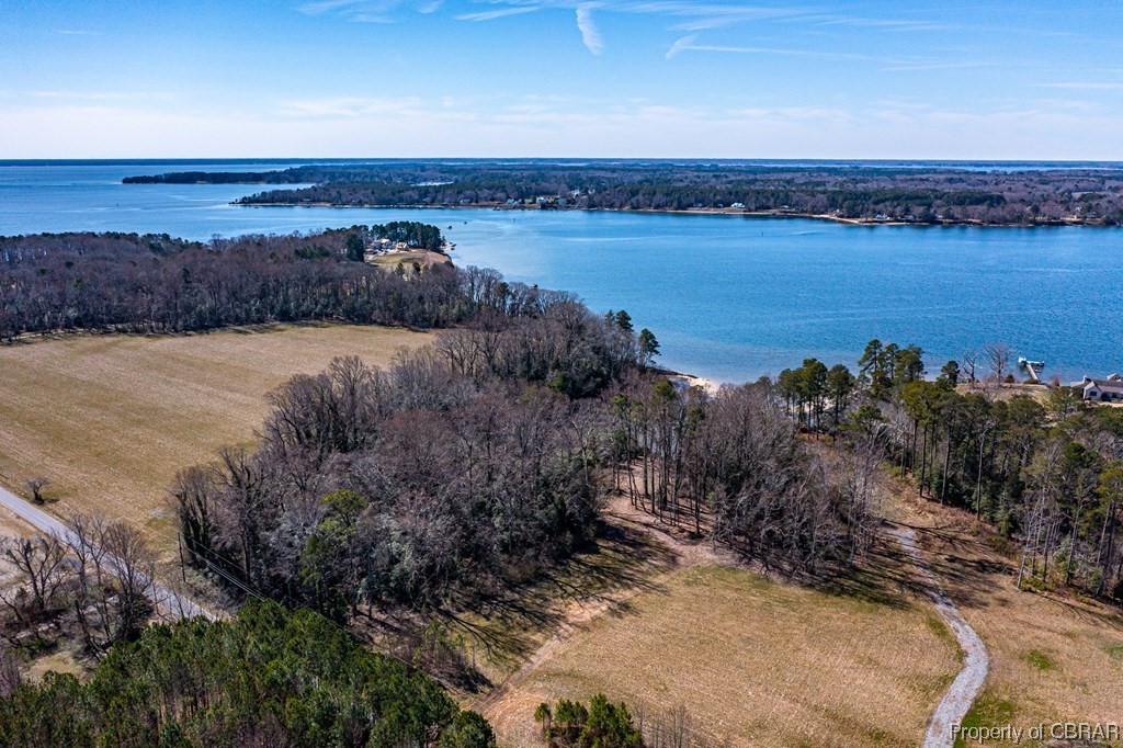 Birds eye view of property with a water view