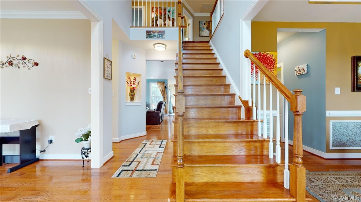 Staircase featuring oak stairs,  light hardwood / wood-style floors