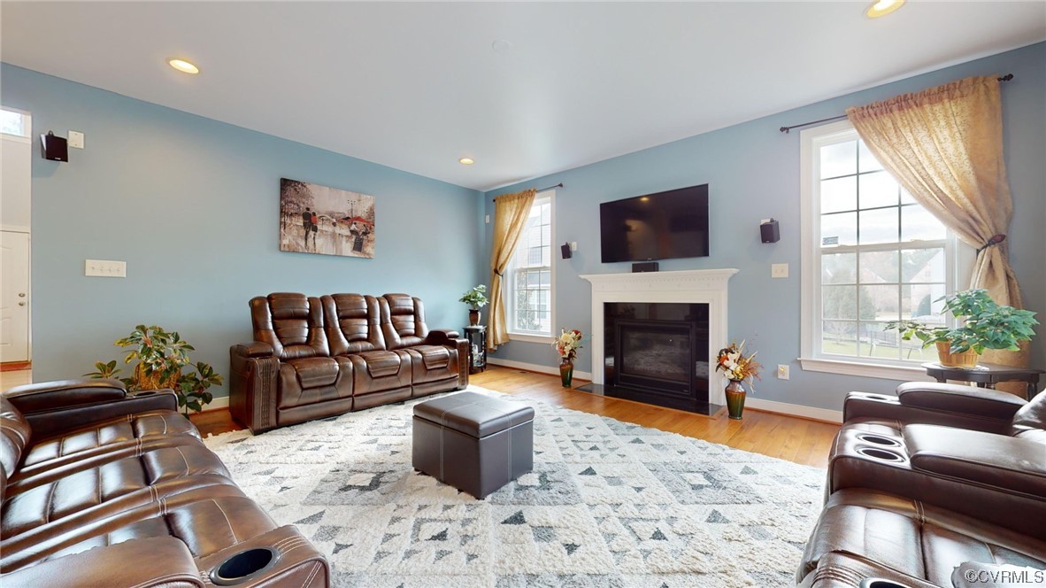 Family room with plenty of natural light, hardwood floors, fireplace