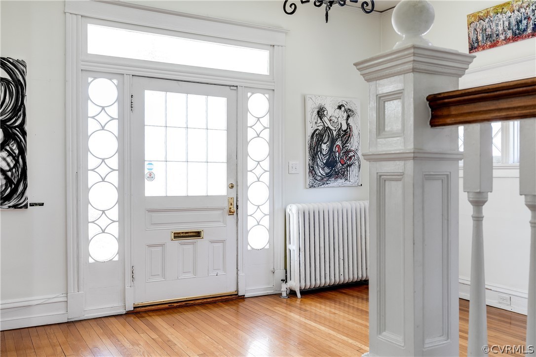 Entrance foyer with radiator and light hardwood / wood-style floors