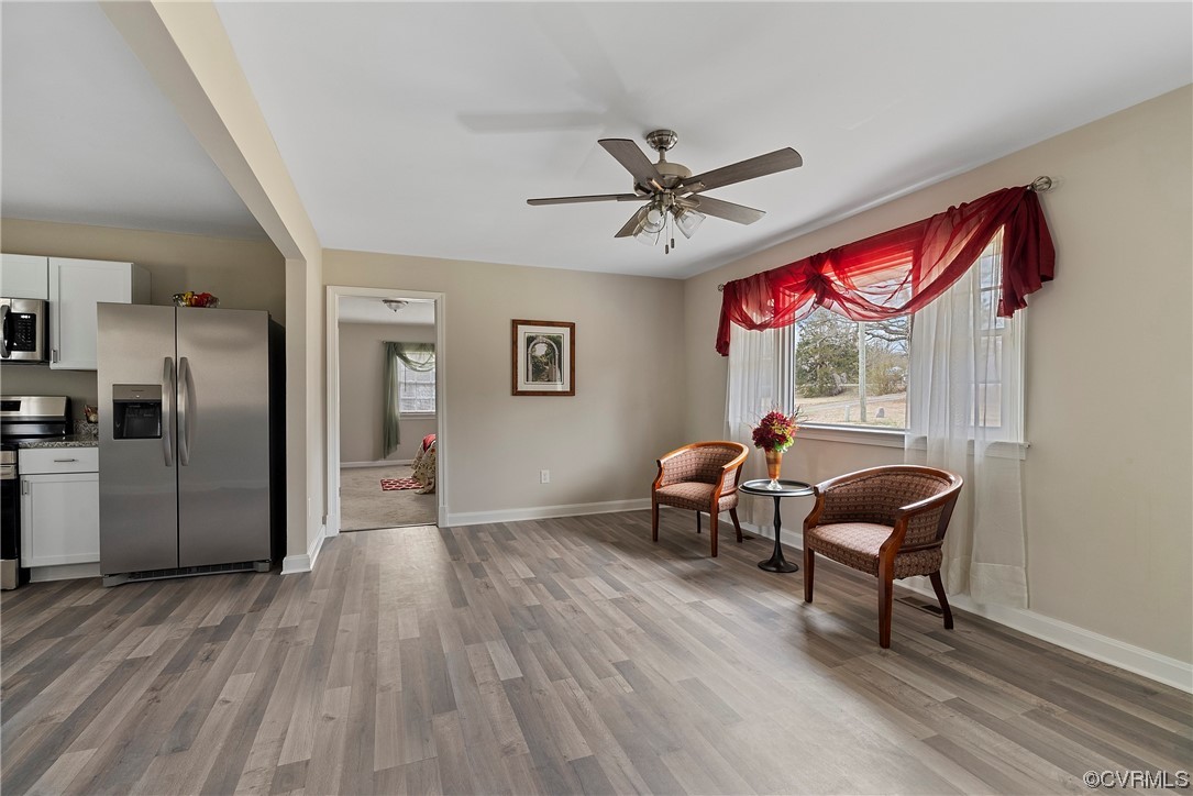 Family room featuring LPV flooring and ceiling fan--open to kitchen