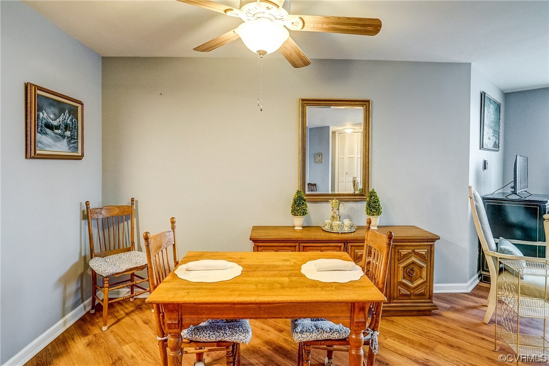 Dining area with light hardwood / wood-style flooring and ceiling fan