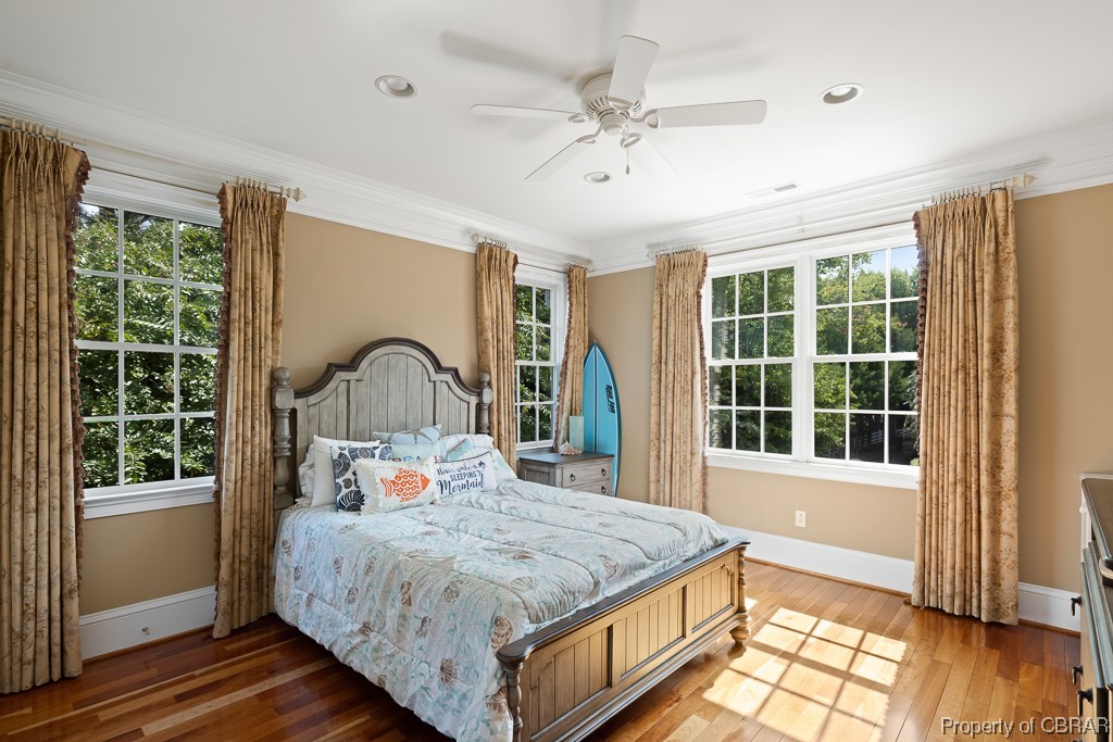 Bedroom with multiple windows and ceiling fan