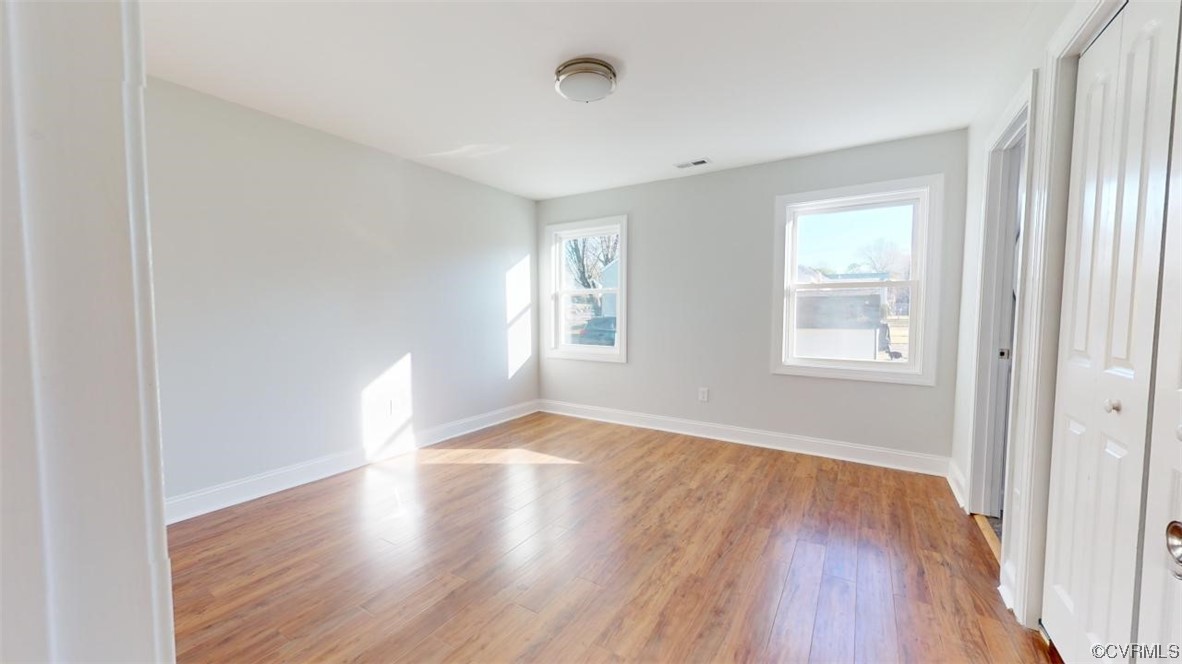 Primary Bedroom with light hardwood / wood-style floors and plenty of natural light