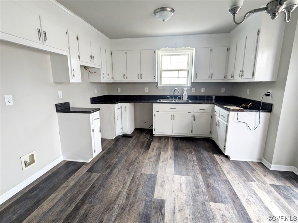 Kitchen featuring sink, dark hardwood / wood-style flooring, and white cabinets