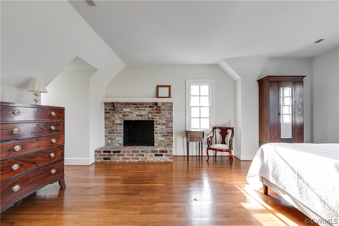 Large bedroom five has a wood-burning brick fireplace.