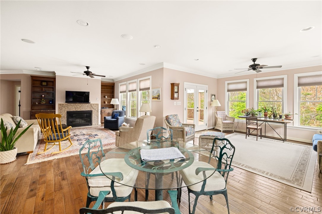 Dining area featuring french doors, a wealth of natural light, light wood-type flooring, and ceiling fan