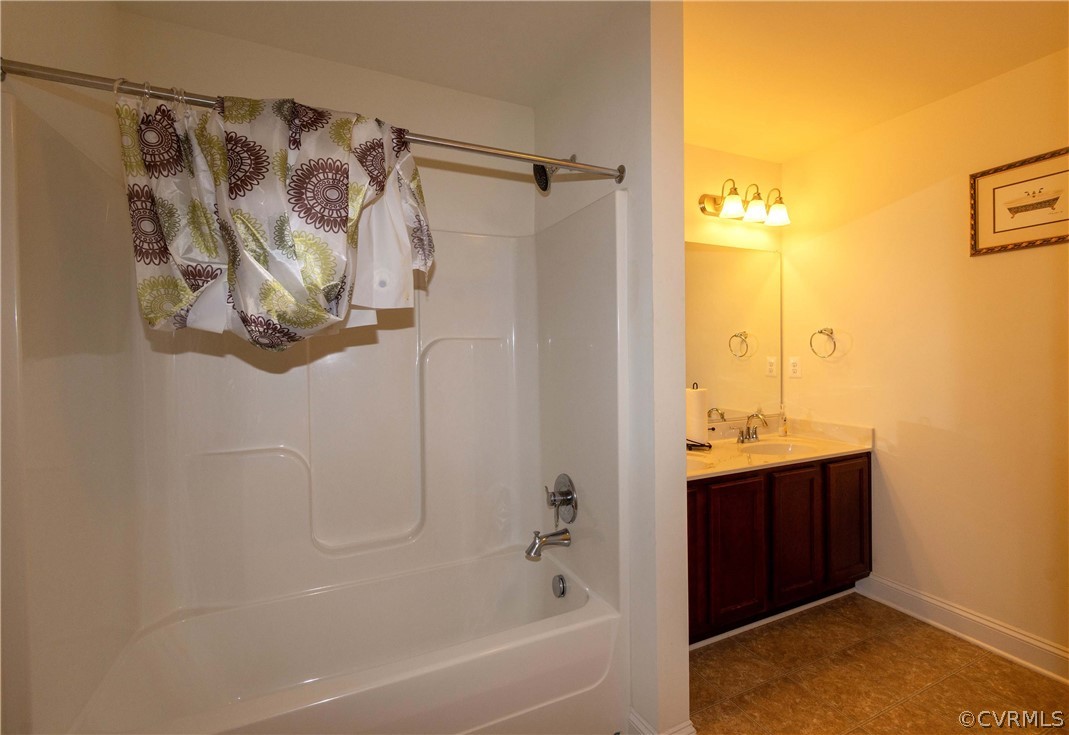 Bathroom featuring vanity, tile flooring, and shower / tub combo with curtain