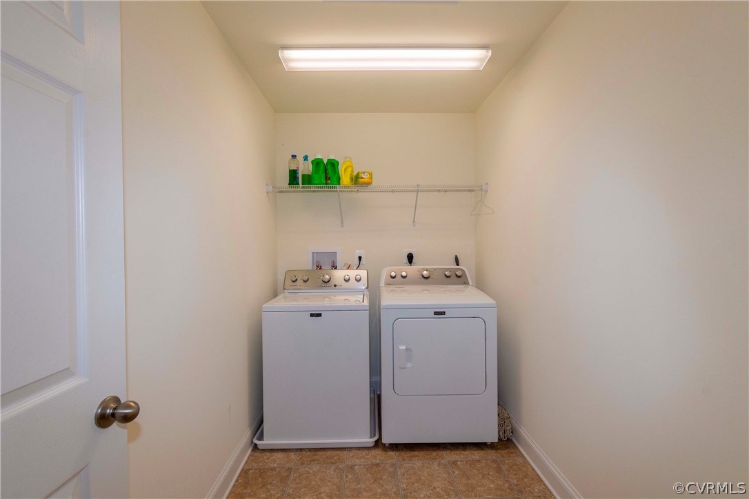 Laundry room featuring light tile flooring, hookup for an electric dryer, washer and clothes dryer, and hookup for a washing machine