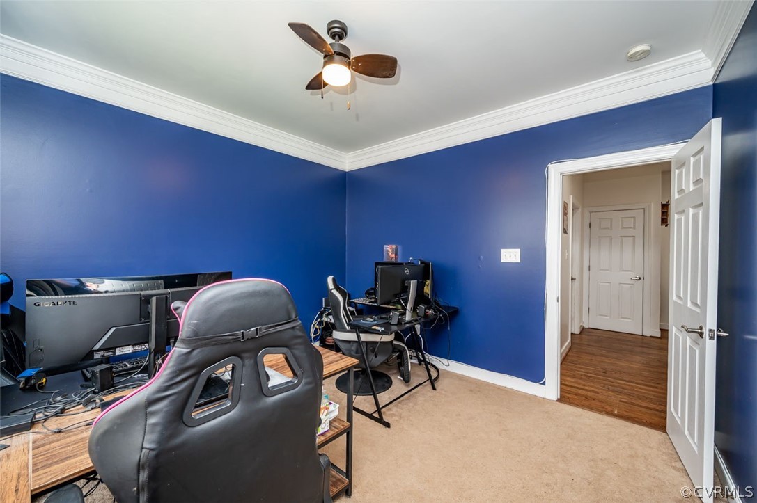 Office with light colored carpet, crown molding, and ceiling fan