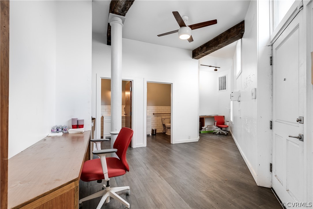 Office space with ceiling fan, a towering ceiling, beamed ceiling, and dark hardwood / wood-style​​‌​​​​‌​​‌‌​‌‌​​​‌‌​‌​‌​‌​​​‌​​ floors