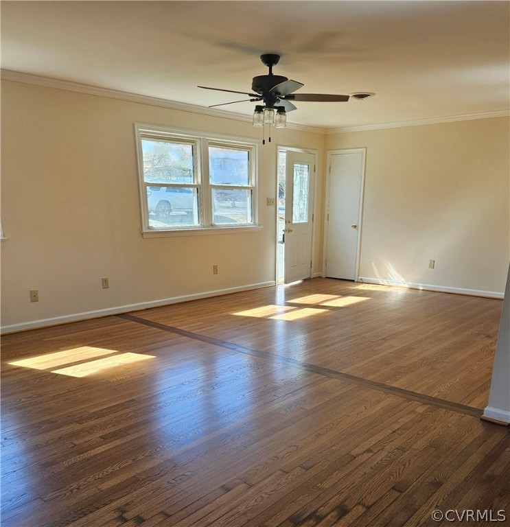Spare room featuring crown molding, ceiling fan, and dark hardwood / wood-style floors