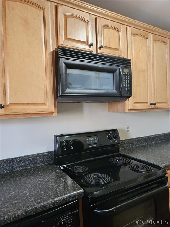 Kitchen featuring light brown cabinets and black appliances