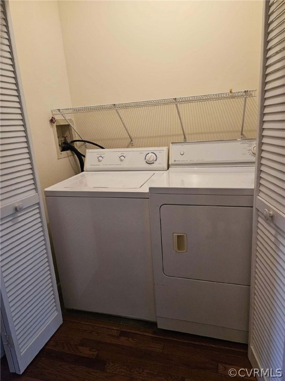 Washroom featuring dark hardwood / wood-style flooring, washer and clothes dryer, and washer hookup