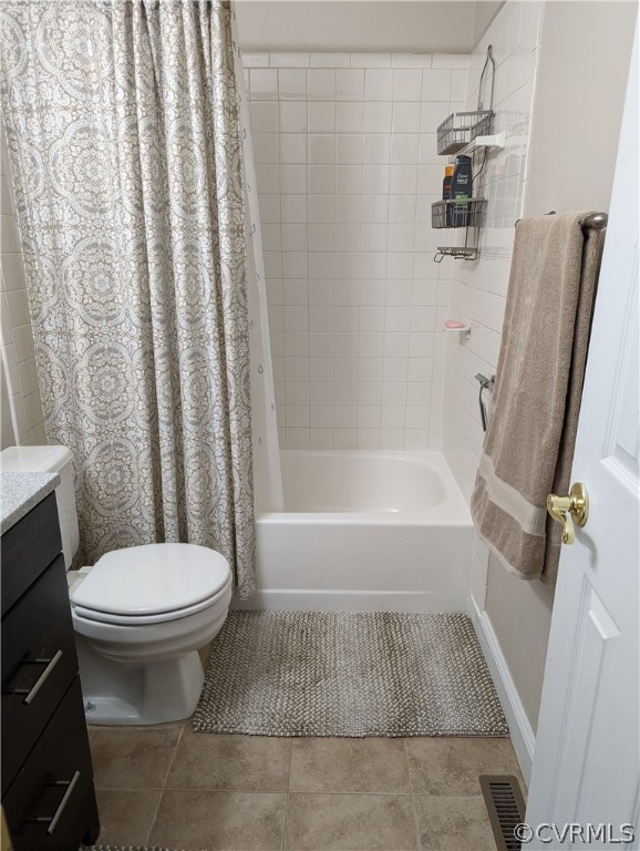Full bathroom with vanity, tile flooring, shower / tub combo with curtain, and toilet