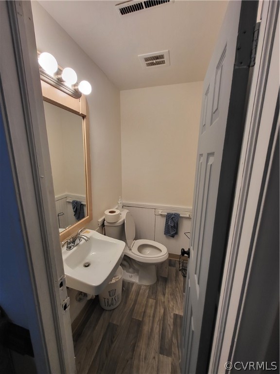 Bathroom featuring sink, hardwood / wood-style floors, and toilet