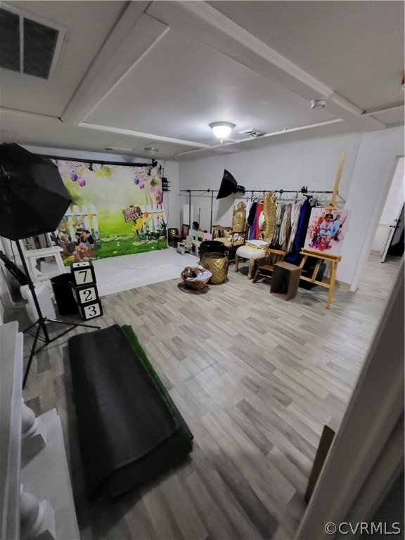 Exercise room featuring light hardwood / wood-style floors
