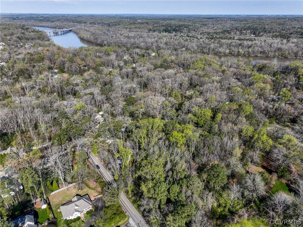 Birds eye view of property with a water view