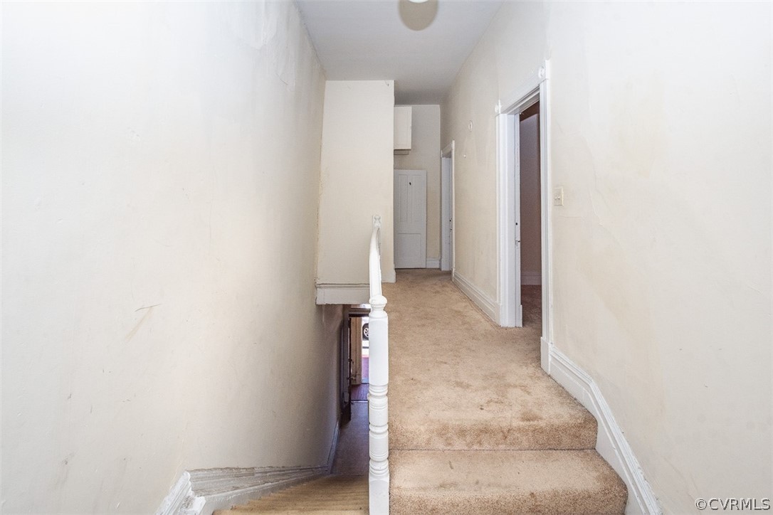 Staircase with light colored carpet