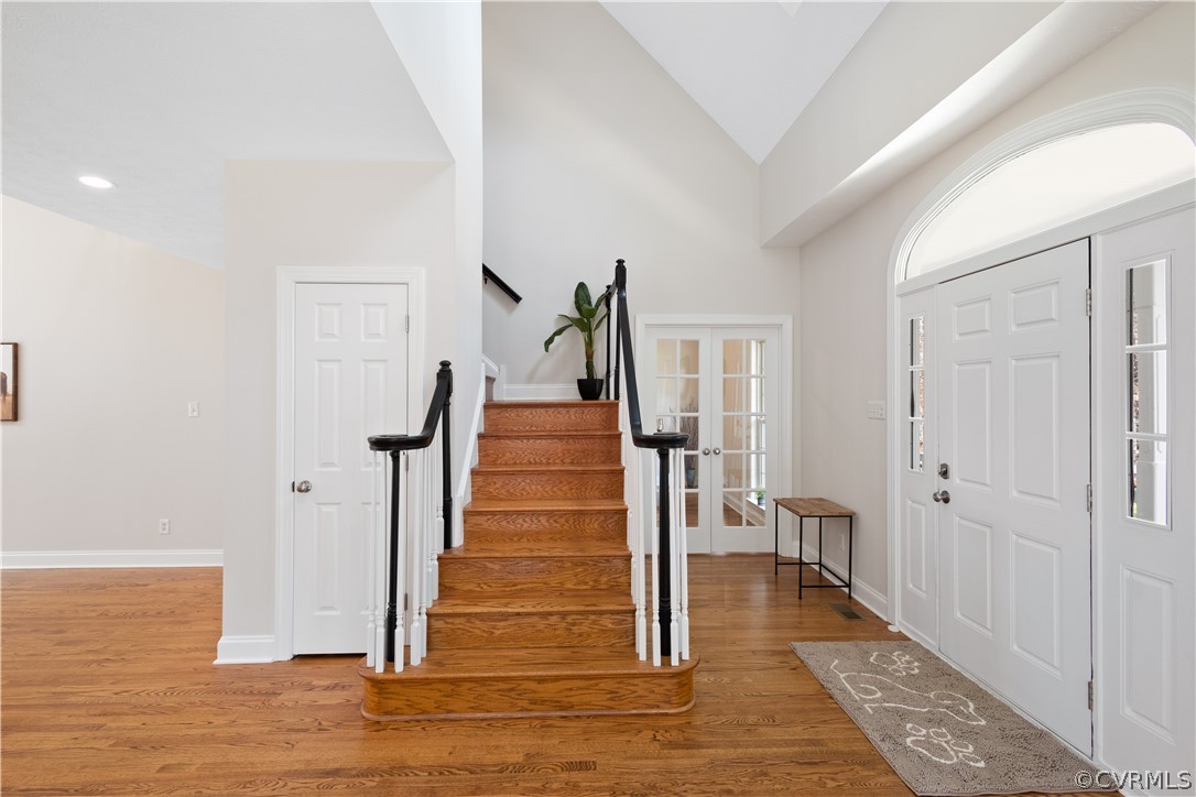Foyer featuring lofted ceiling, light hardwood / wood-style flooring, and french doors