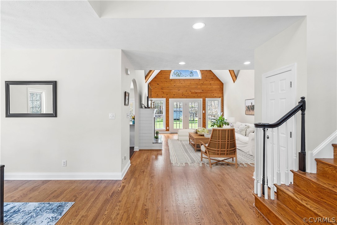 Entryway featuring lofted ceiling with beams and light hardwood / wood-style floors