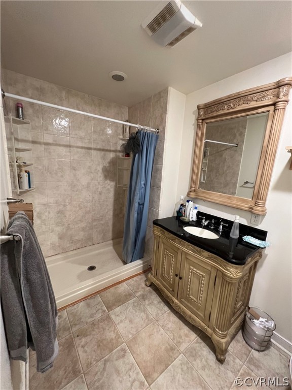 Bathroom with oversized vanity, tile floors, and a shower with shower curtain