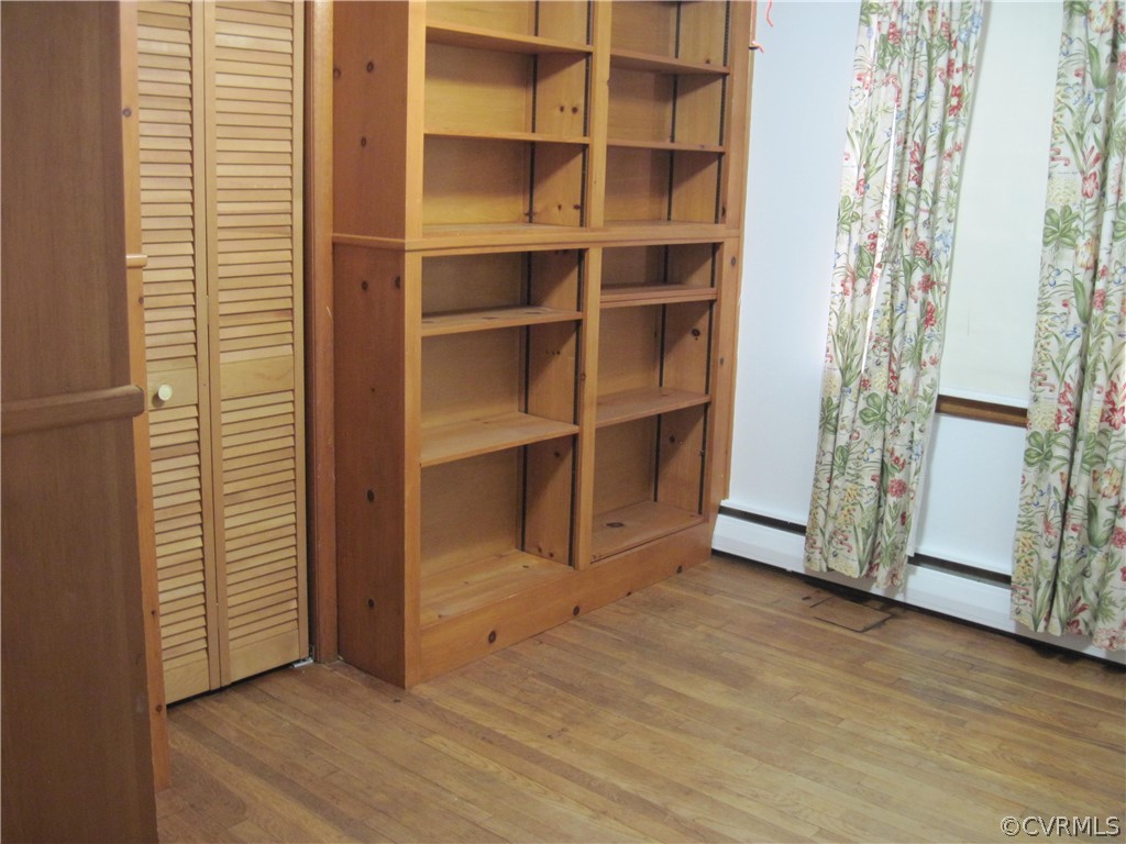 Third bedroom hardwood floors & bookcases.