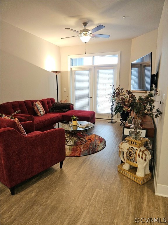 Living room featuring ceiling fan and hardwood / wood-style flooring