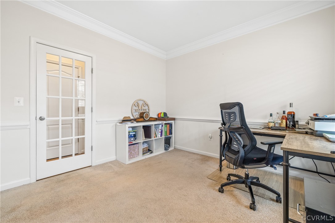 Office space featuring ornamental molding and light colored carpet