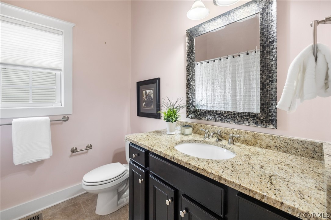 Full Bath on main level with granite top vanity and ceramic floors, a tub/shower and is adjacent to the Bedrooms