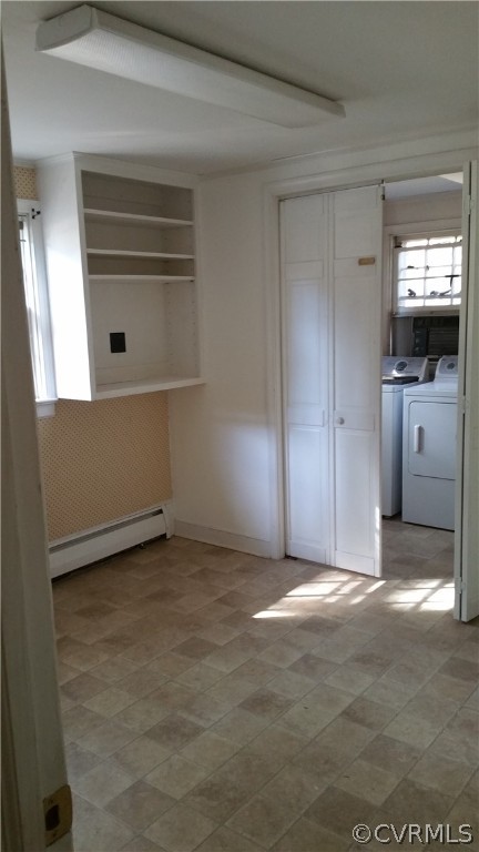 Unfurnished bedroom with light tile floors, washing machine and dryer, a baseboard radiator, and a closet