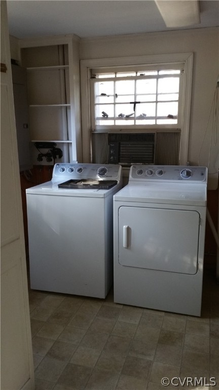 Laundry room with washer and clothes dryer, light tile floors, and a wealth of natural light