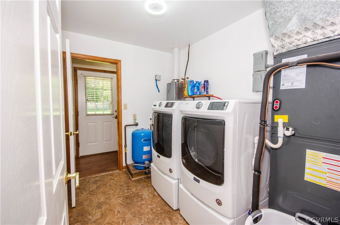Laundry room with washing machine and clothes dryer and tile flooring