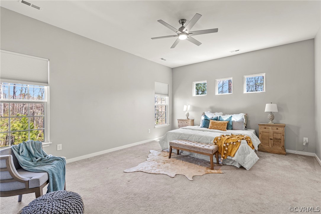 Luxuary first floor primary with modern ceiling fan, natural light  10 foot ceilings and WIC of your dreams