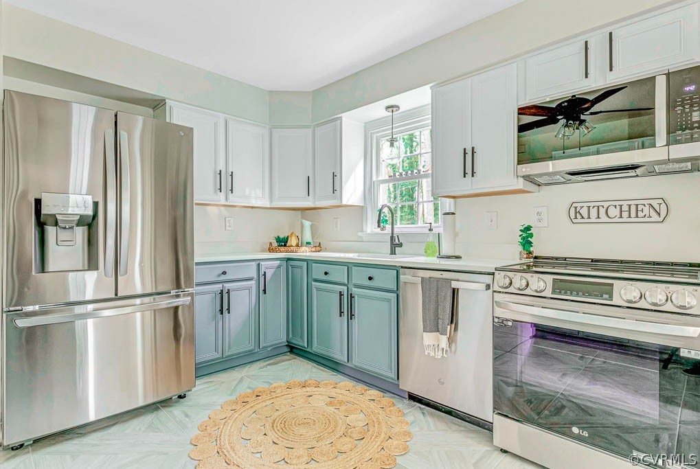 Kitchen featuring white cabinets, sink, and stainless steel appliances