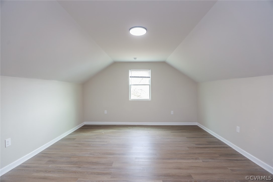 Bonus room featuring light hardwood / wood-style floors and vaulted ceiling
