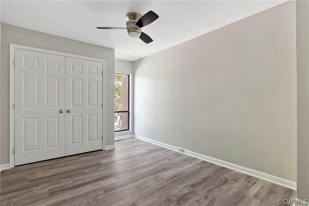 Unfurnished bedroom with a closet, ceiling fan, and light hardwood / wood-style flooring