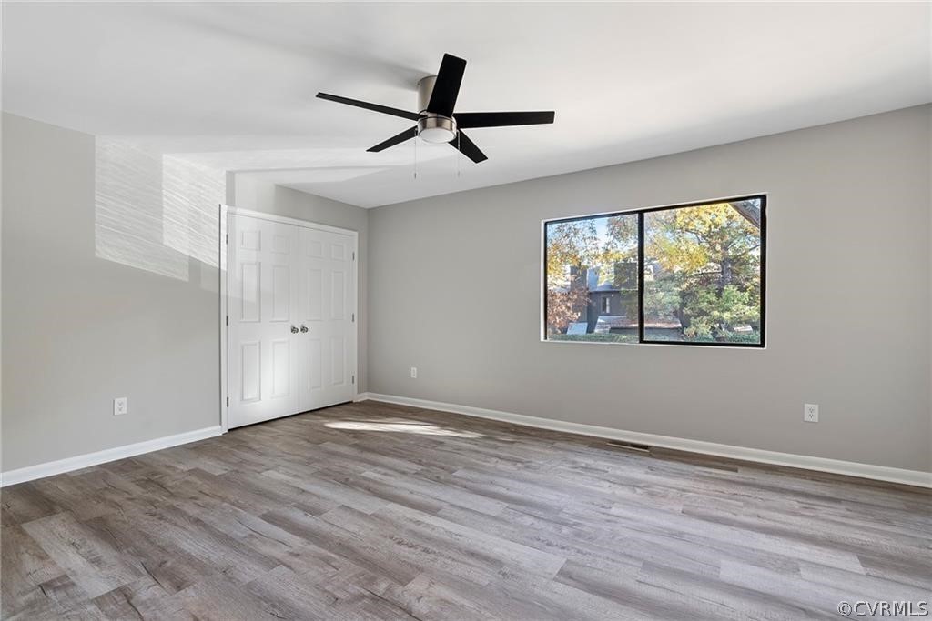 Spare room with ceiling fan and light wood-type flooring