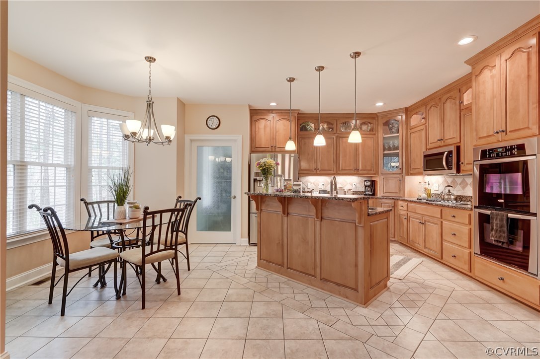 Kitchen with nook, with view of backyard, granite countertops, stainless steel appliances