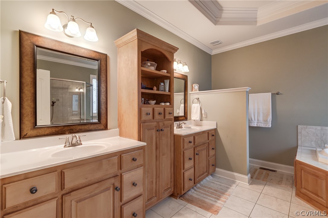 Ensuite Bathroom with sunken tub (jets) an enclosed shower, crown molding, tile floors, double vanity, and a raised ceiling