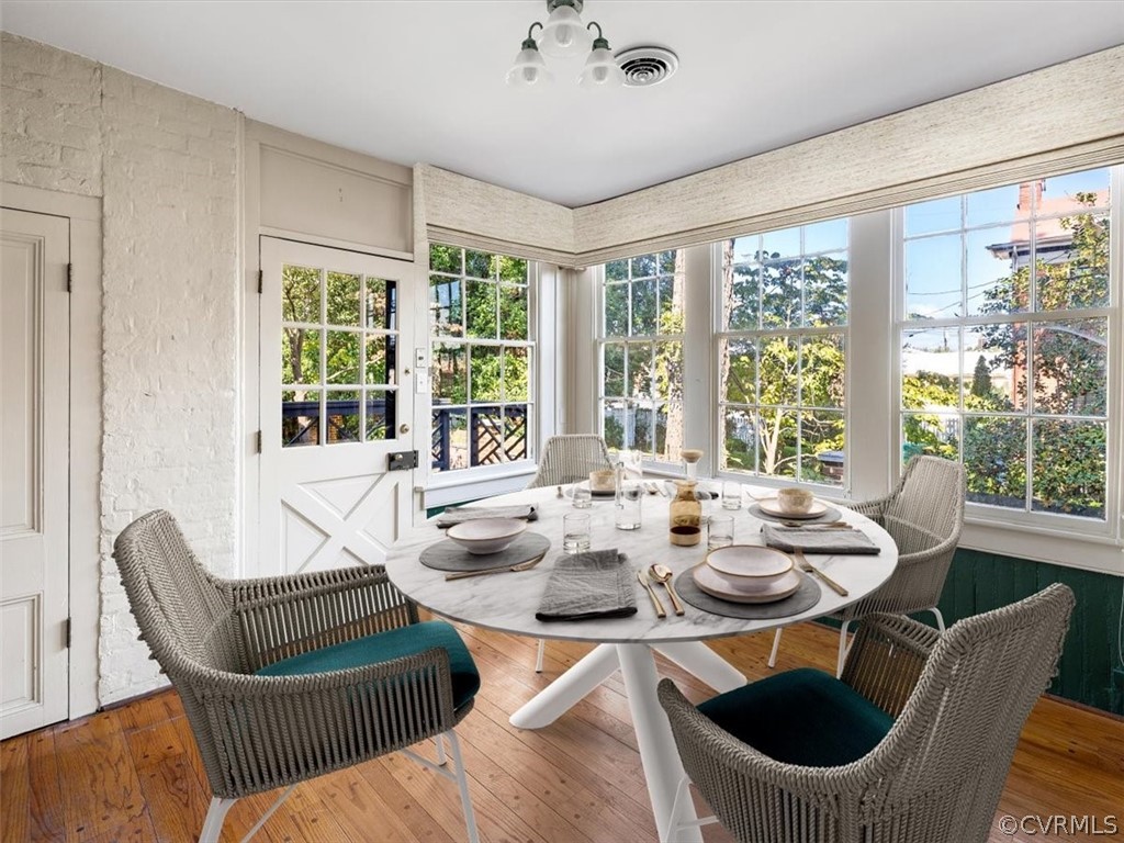 The breakfast room overlooks the garden and opens to a deck and a rear suite (virtual staging).