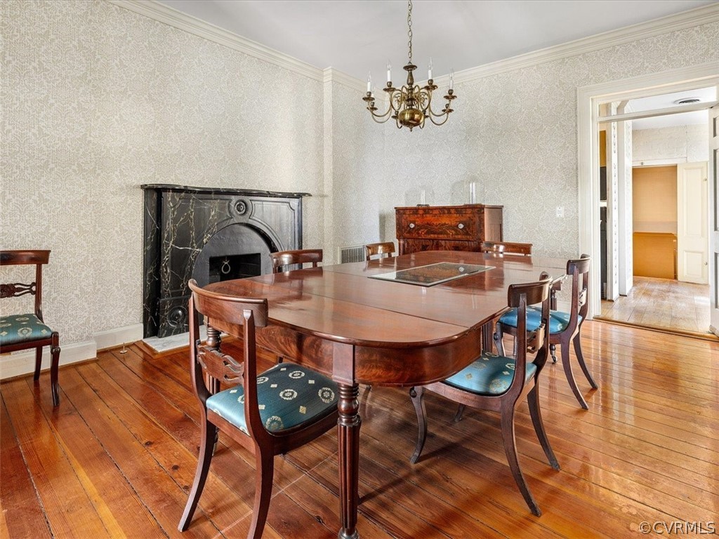 A stone mantel and an antique  floor grace the formal dining room