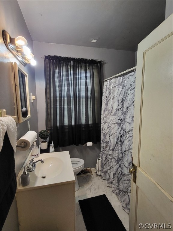 Bathroom tile flooring, toilet, and large vanity
