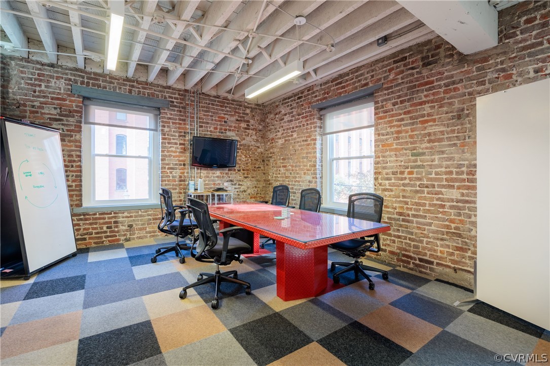 Office space featuring brick wall