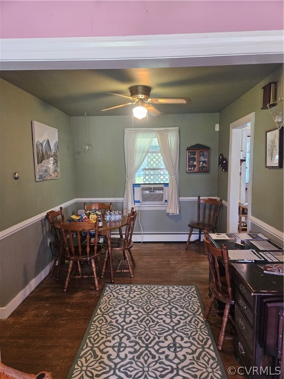 Dining room with ceiling fan, dark hardwood / wood-style floors, and a baseboard radiator