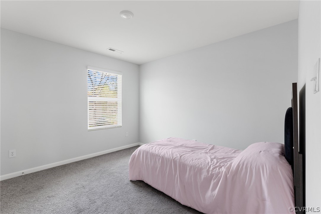 Bedroom 2 with light colored carpet