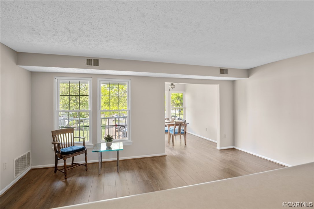 Fresh paint and new Luxury plank flooring.  Loads of light and open to the kitchen and dining room/sunroom.