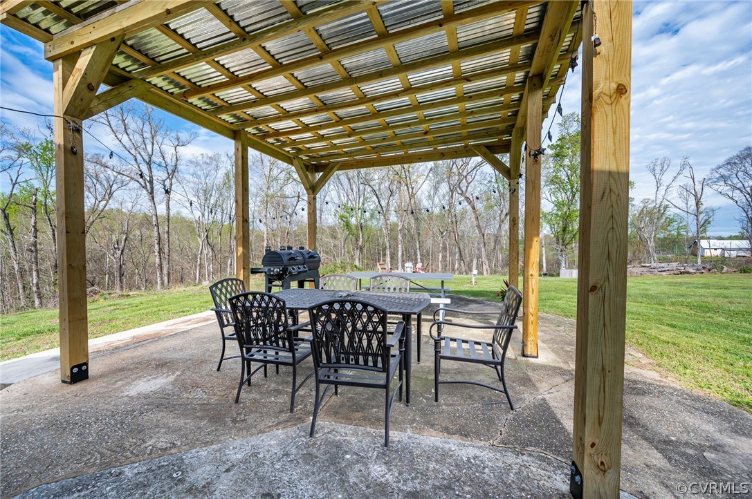 View of patio featuring a pergola and area for grilling