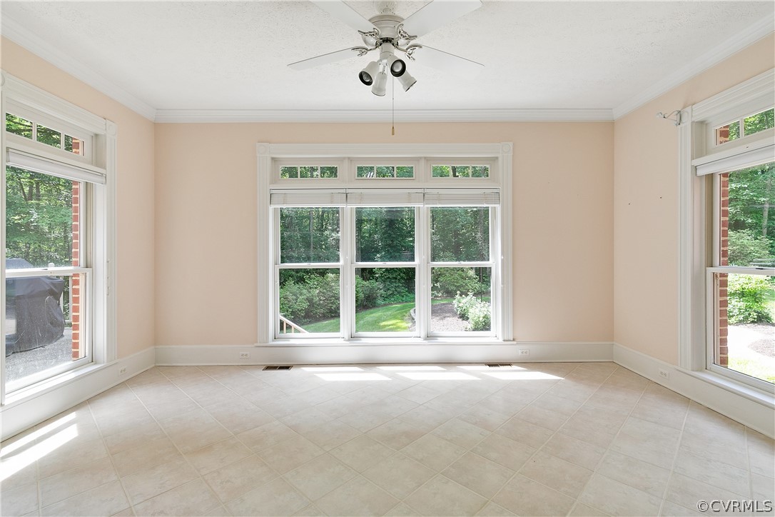 Interior space featuring ceiling fan and light tile floors