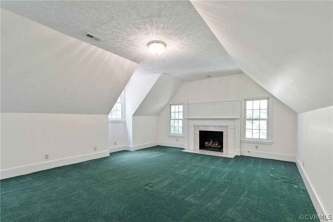 Living room with light carpet and lofted ceiling